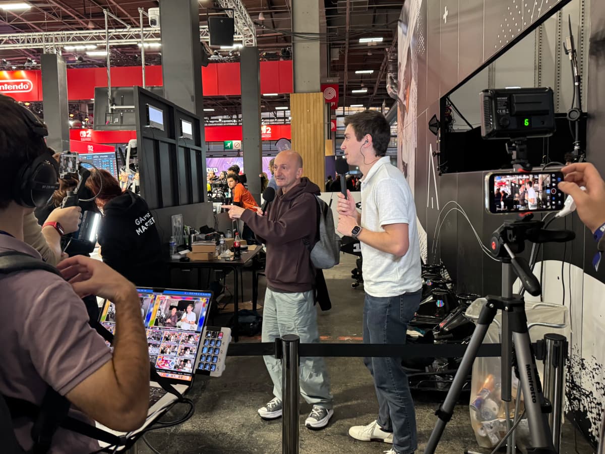Arthur and PP Garcia, microphones in hand, filmed backstage at the Eva stand.